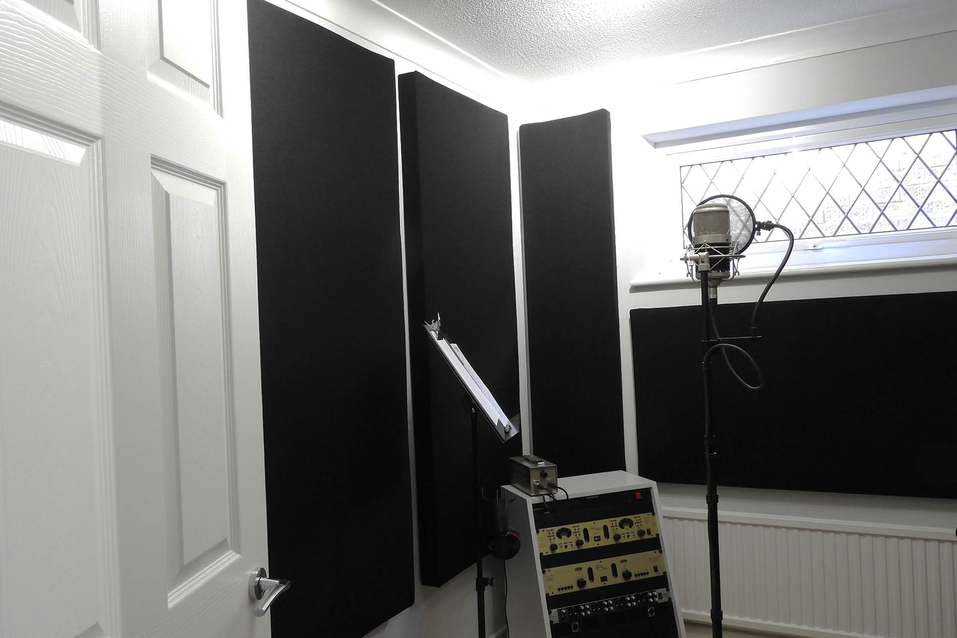 DIY acoustic panels finished and installed on stud wall in mic. room